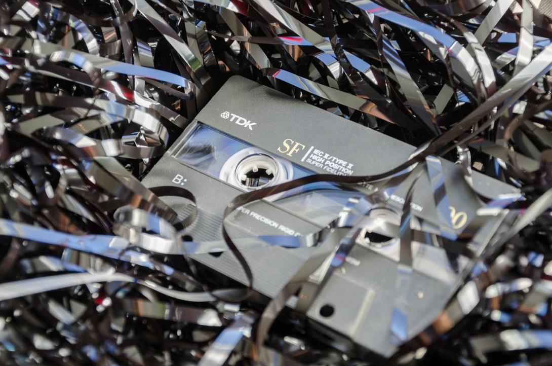 a TDK casette tape sitting in a pile of its own innards